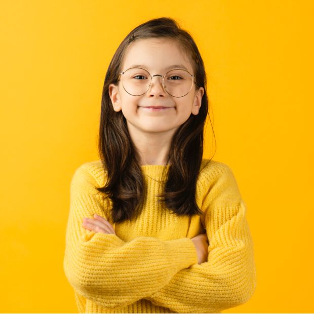 young girl with glasses on yellow backdrop