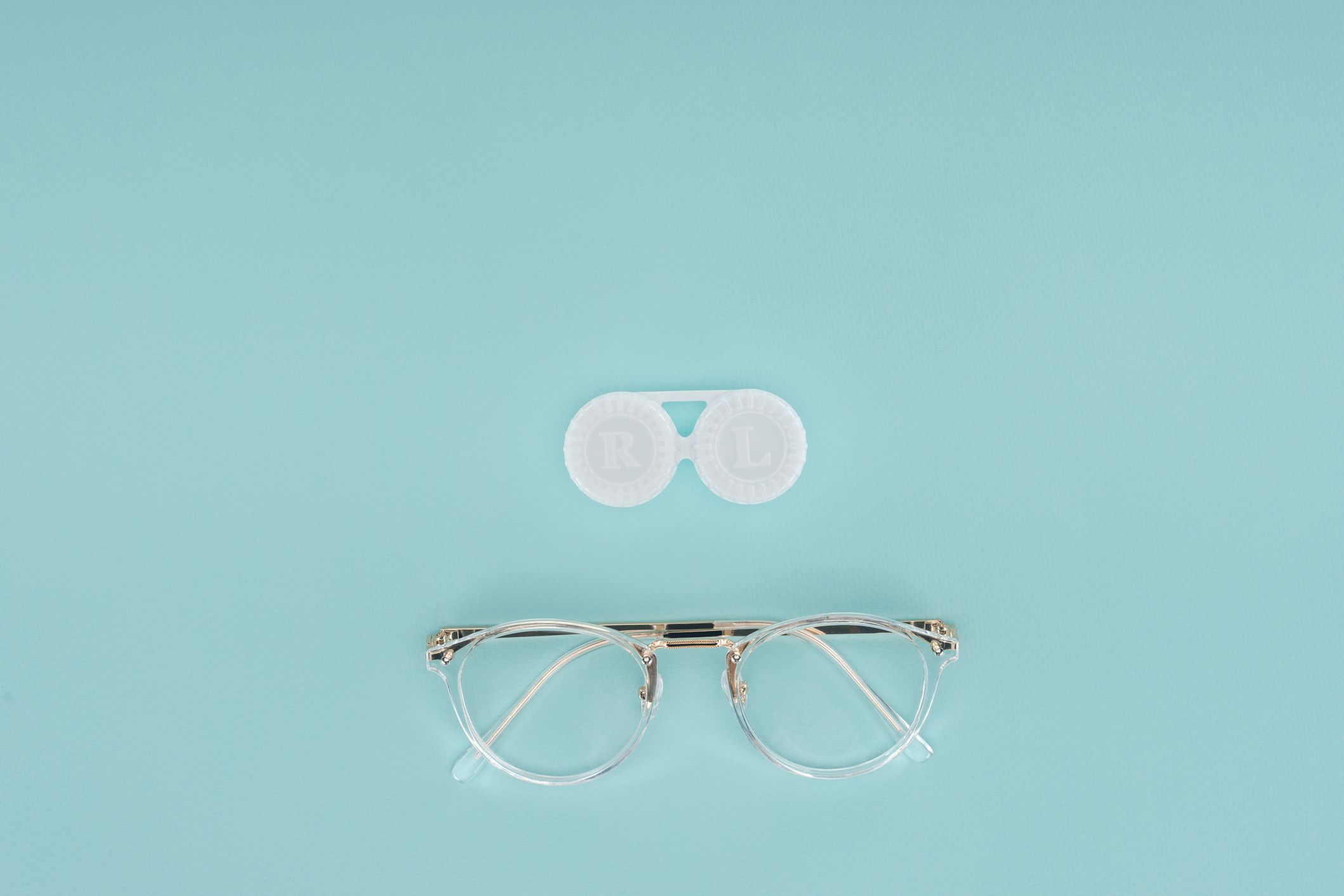 glasses and contact lens on blue backdrop