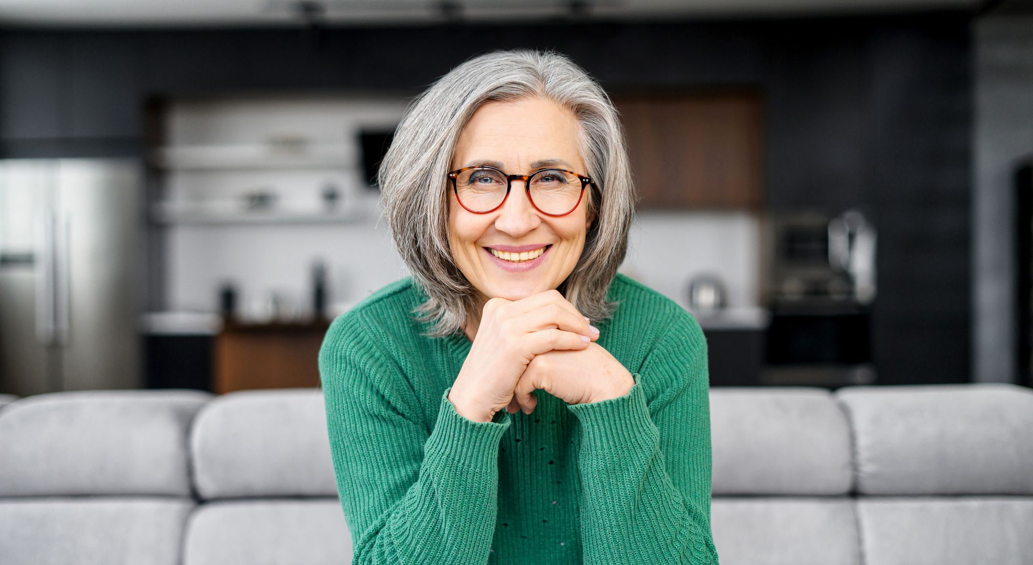 older woman smiling with glasses on