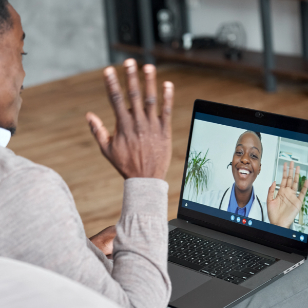 man waving at woman on laptop